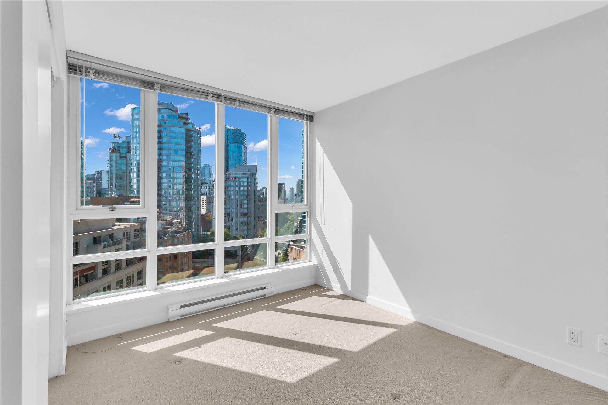 Downtown Vancouver skyline from a bright bedroom
